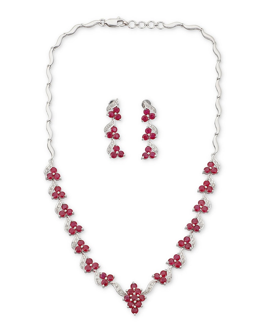 An 18K White Gold, Ruby and Diamond Necklace and Earring Set Of stylized wave design, set (1 of 3)