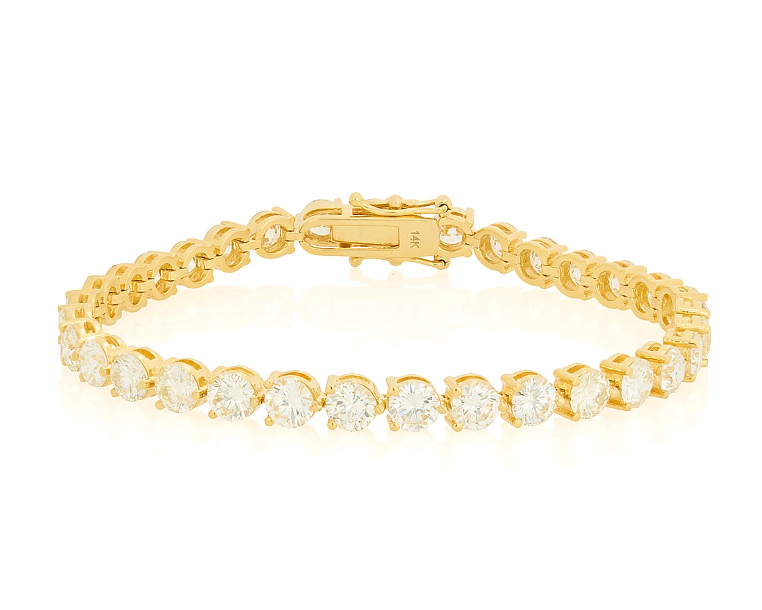 A 14K Gold and Diamond Bracelet Of a single line design featuring thirty-three round diamonds (1 of 3)
