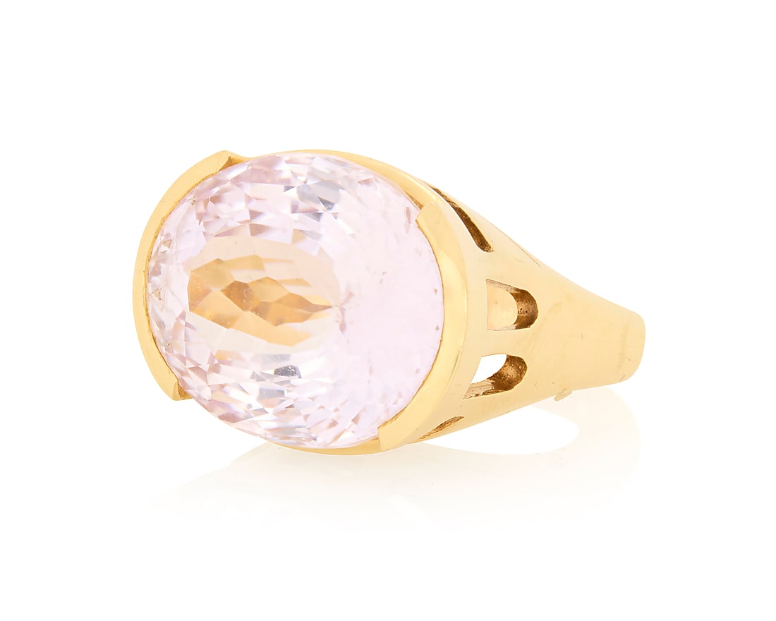 An 18K Gold and Kunzite Ring Centering an oval kunzite weighing approximately 38.68 carats, set in (1 of 3)