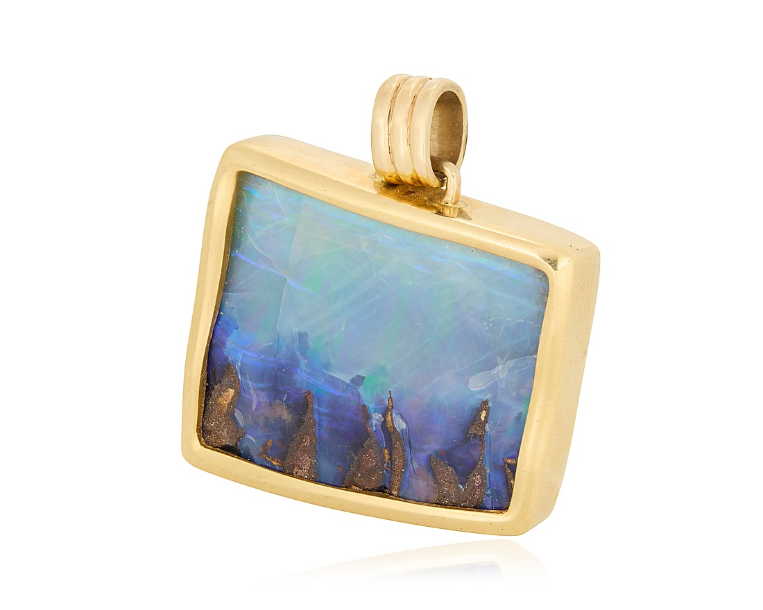 A 14K Gold and Boulder Opal Pendant Of an organic design centering a boulder opal measuring (1 of 3)