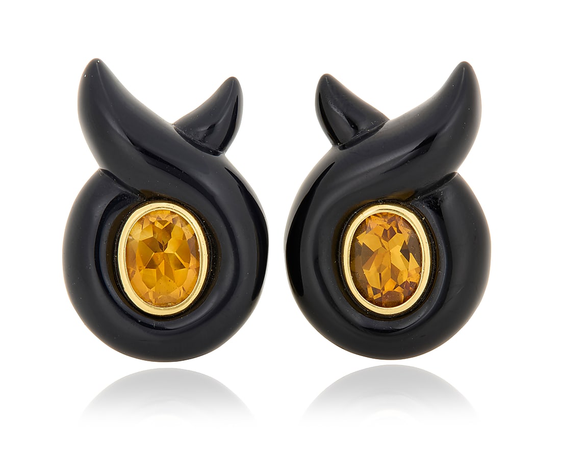 Verdura: A Pair of 18K Gold, Citrine and Onyx Earclips Featuring carved twisted onyx, centering: Verdura: A Pair of 18K Gold, Citrine and Onyx Earclips Featuring carved twisted onyx, centering two oval citrines, signed Verdura, 23286 2 pieces Measures: 1 x 3/4 in. 17.2 grams gross