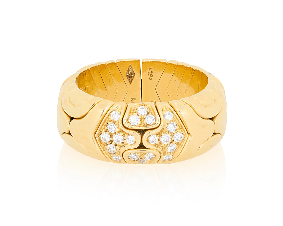 Bulgari: An 18K Gold and Diamond 'Parentesi' Ring Of an open flexible design featuring: Bulgari: An 18K Gold and Diamond 'Parentesi' Ring Of an open flexible design featuring interlocking high polish gold elements accented by round diamonds, signed Bulgari with Italian workshop marks Siz