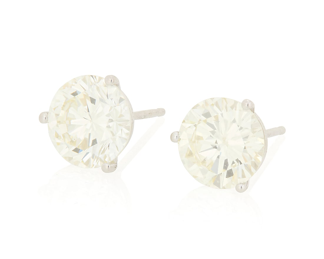 A Pair of 14K White Gold and Diamond Stud Earrings Centering two round diamonds weighing: A Pair of 14K White Gold and Diamond Stud Earrings Centering two round diamonds weighing approximately 1.70 and 2.00 carats 2 pieces Measures: 3/8 in. 1.8 grams gross