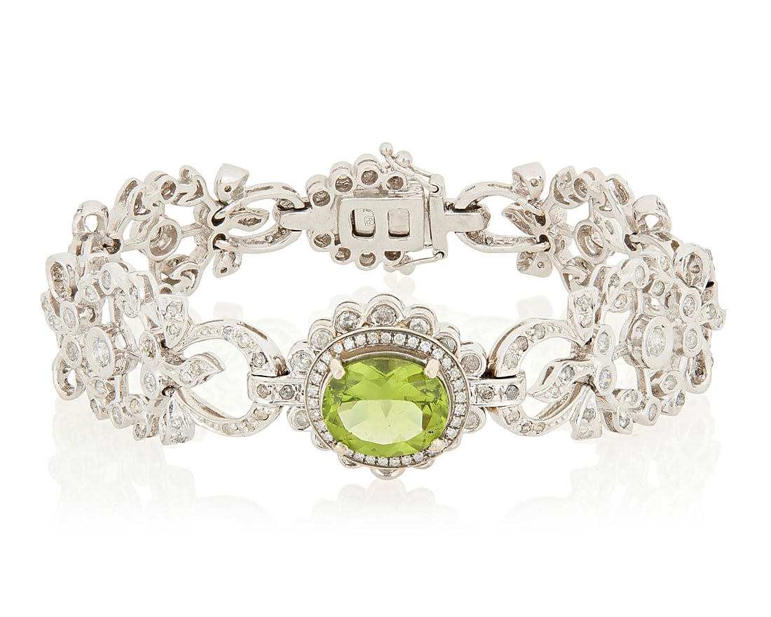An 18K White Gold, Peridot and Diamond Bracelet Centering an oval peridot weighing approximately (1 of 3)