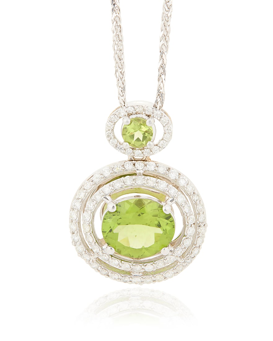 A 14K White Gold, Peridot and Diamond Necklace Featuring two oval peridots weighing approximately (1 of 3)