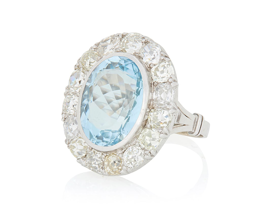 A 14K White Gold, Aquamarine and Diamond Ring Centering an oval aquamarine weighing approximately (1 of 3)
