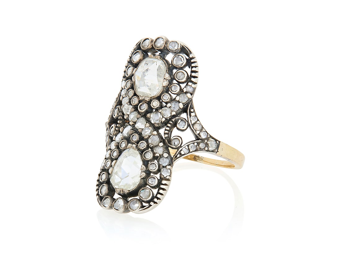 A Silver Topped-Gold and Rose-Cut Diamond Ring Featuring an ornate infinity design centering two: A Silver Topped-Gold and Rose-Cut Diamond Ring Featuring an ornate infinity design centering two pear-shaped rose-cut diamond, accented by round rose-cut diamonds Size: 7 3/4 7.4 grams gross