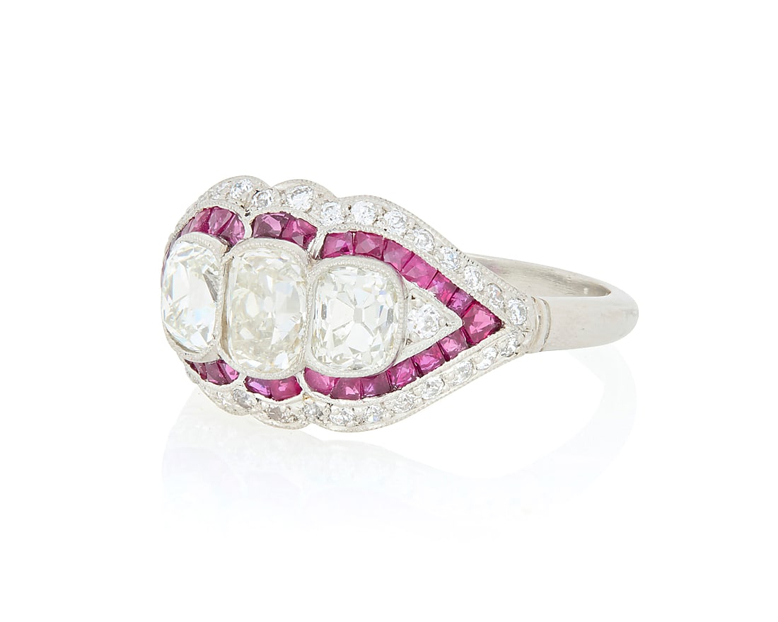 A Platinum, Diamond and Ruby Ring Featuring three old mine-cut diamonds weighing approximately (1 of 3)