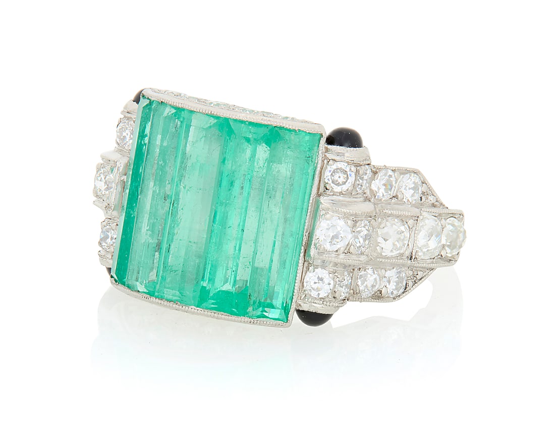An Art Deco Platinum, Emerald and Diamond Ring Centering five elongated baguette emeralds weighing (1 of 3)