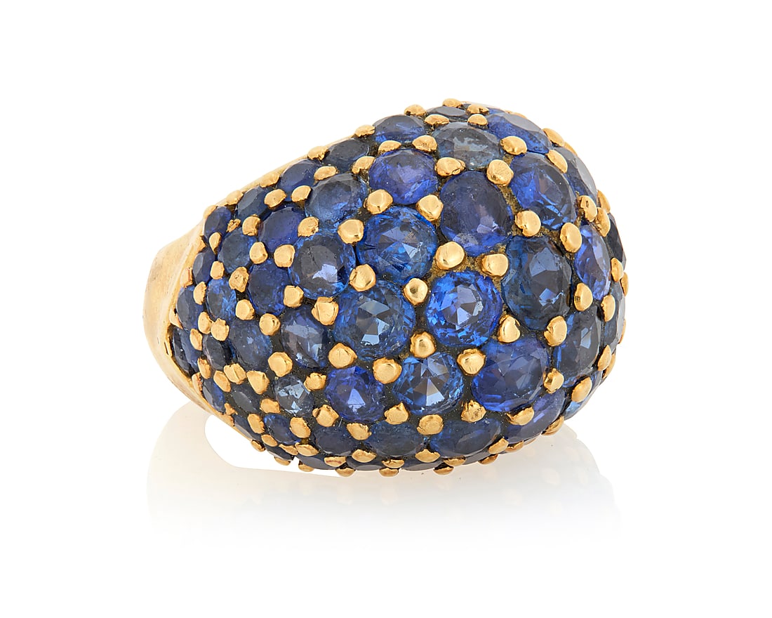 An 18K Gold and Sapphire Ring Of a bombe design set with graduated round sapphires, with French: An 18K Gold and Sapphire Ring Of a bombe design set with graduated round sapphires, with French assay marks Size: 4 3/4 15.5 grams gross