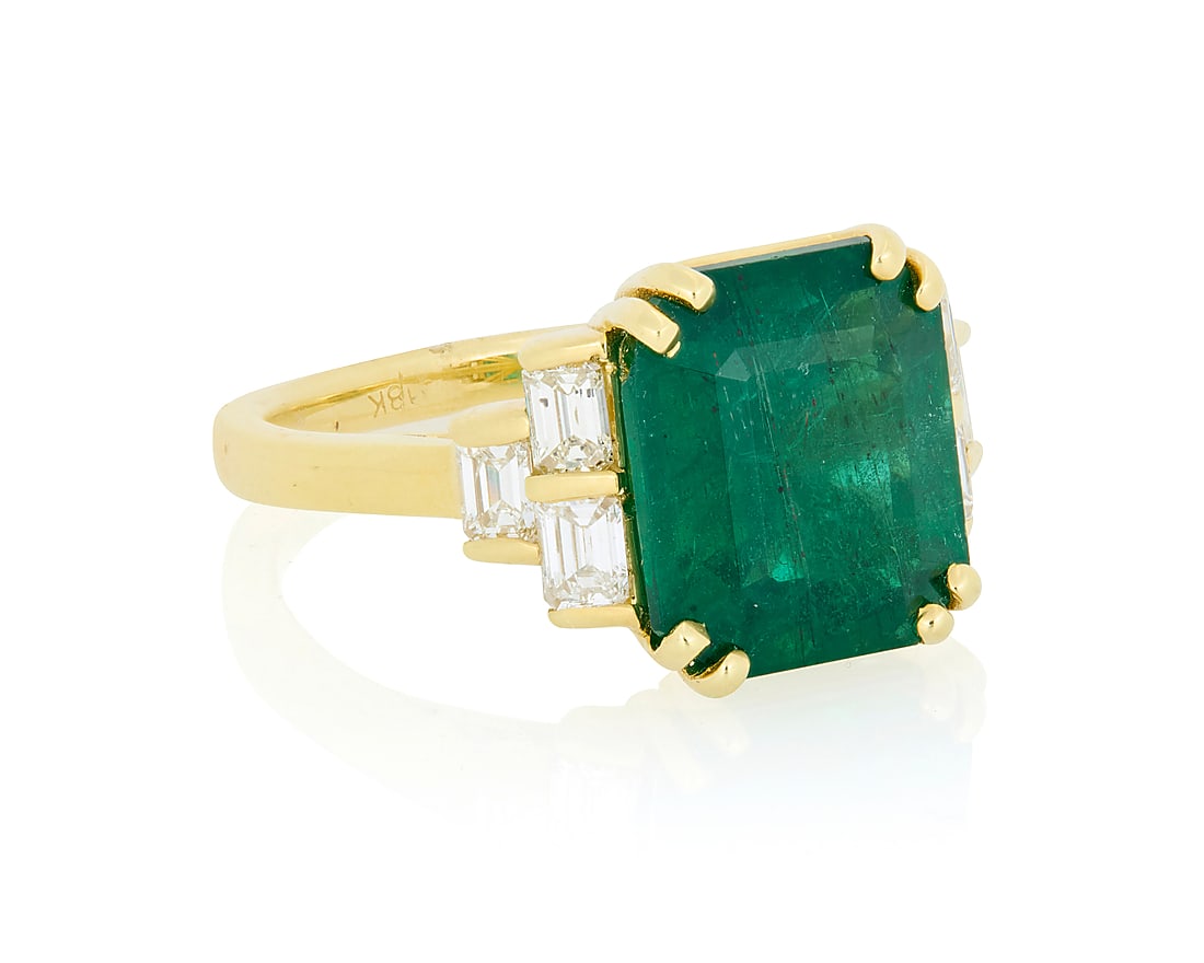 A 18K Gold, Emerald and Diamond Ring Featuring an emerald-cut emerald weighing approximately 6.15: A 18K Gold, Emerald and Diamond Ring Featuring an emerald-cut emerald weighing approximately 6.15 carats, accented by round diamonds weighing approximately 0.78 carat total Size: 7 1/2 7.6 grams gross