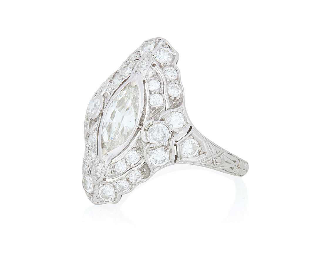 A Platinum and Diamond Ring Centering a marquise-shaped diamond weighing approximately 0.80 carat, (1 of 4)