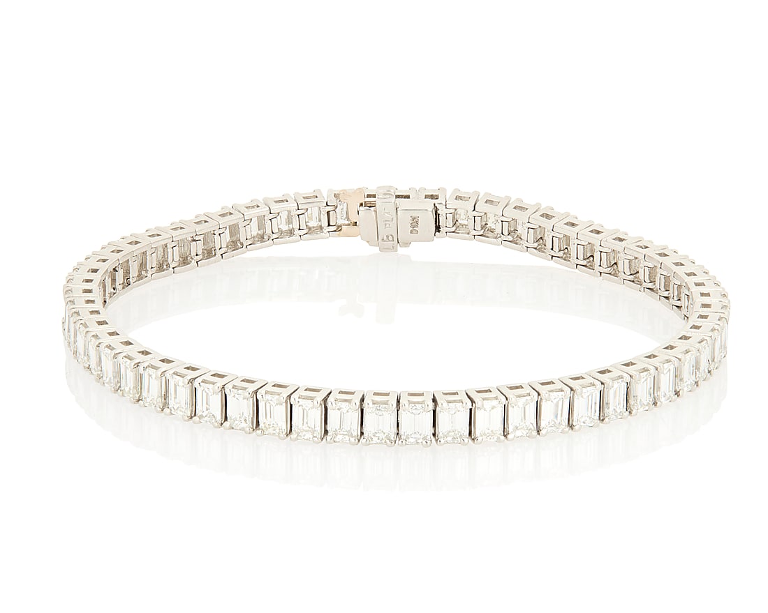 A Platinum and Diamond Bracelet Of a single line design featuring fifty-eight emerald-cut diamonds (1 of 3)