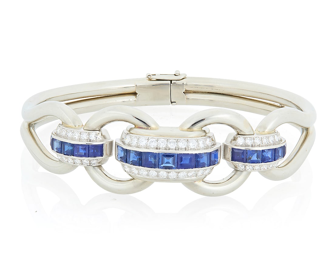 An 18K White Gold, Sapphire and Diamond Bracelet Of an open link design featuring domed channels: An 18K White Gold, Sapphire and Diamond Bracelet Of an open link design featuring domed channels set with sapphires and single-cut diamonds, estimated total diamond weight 1.35 carats Inner Circumfere
