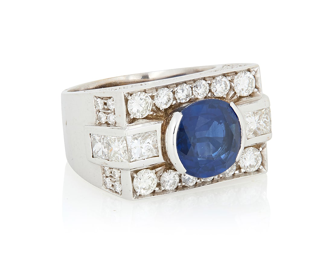 A 14K White Gold, Sapphire and Diamond Ring Centering an oval sapphire ring weighing approximately (1 of 3)