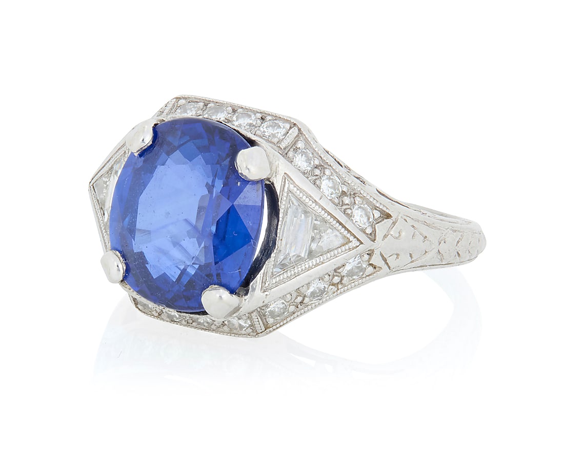 A Platinum, Sapphire and Diamond Ring Centering a Cushion mixed-cut sapphire weighing 5.06 carats,: A Platinum, Sapphire and Diamond Ring Centering a Cushion mixed-cut sapphire weighing 5.06 carats, accented by round and French-cut diamonds Size: 7 1/4 9.3 grams gross Accompanied by a GIA Report num