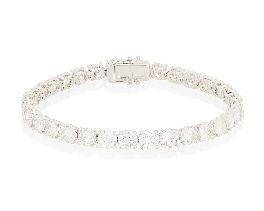 An 18K White Gold and Diamond Bracelet Of a single line design featuring thirty round diamonds (1 of 3)
