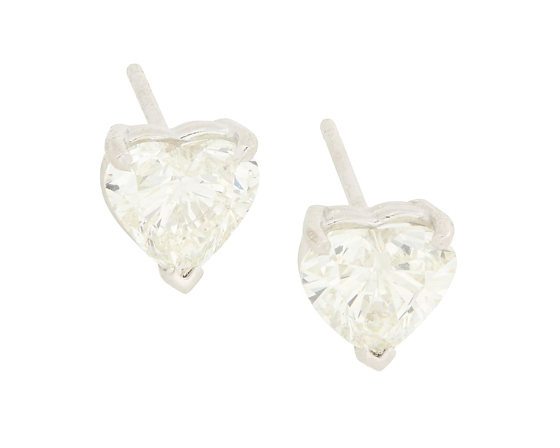A Pair of 14K White Gold and Diamond Studs Centering two heart-shaped diamonds weighing: A Pair of 14K White Gold and Diamond Studs Centering two heart-shaped diamonds weighing approximately 1.01 and 1.02 carats 2 pieces Measures: 1/4 in. 1.6 grams gross