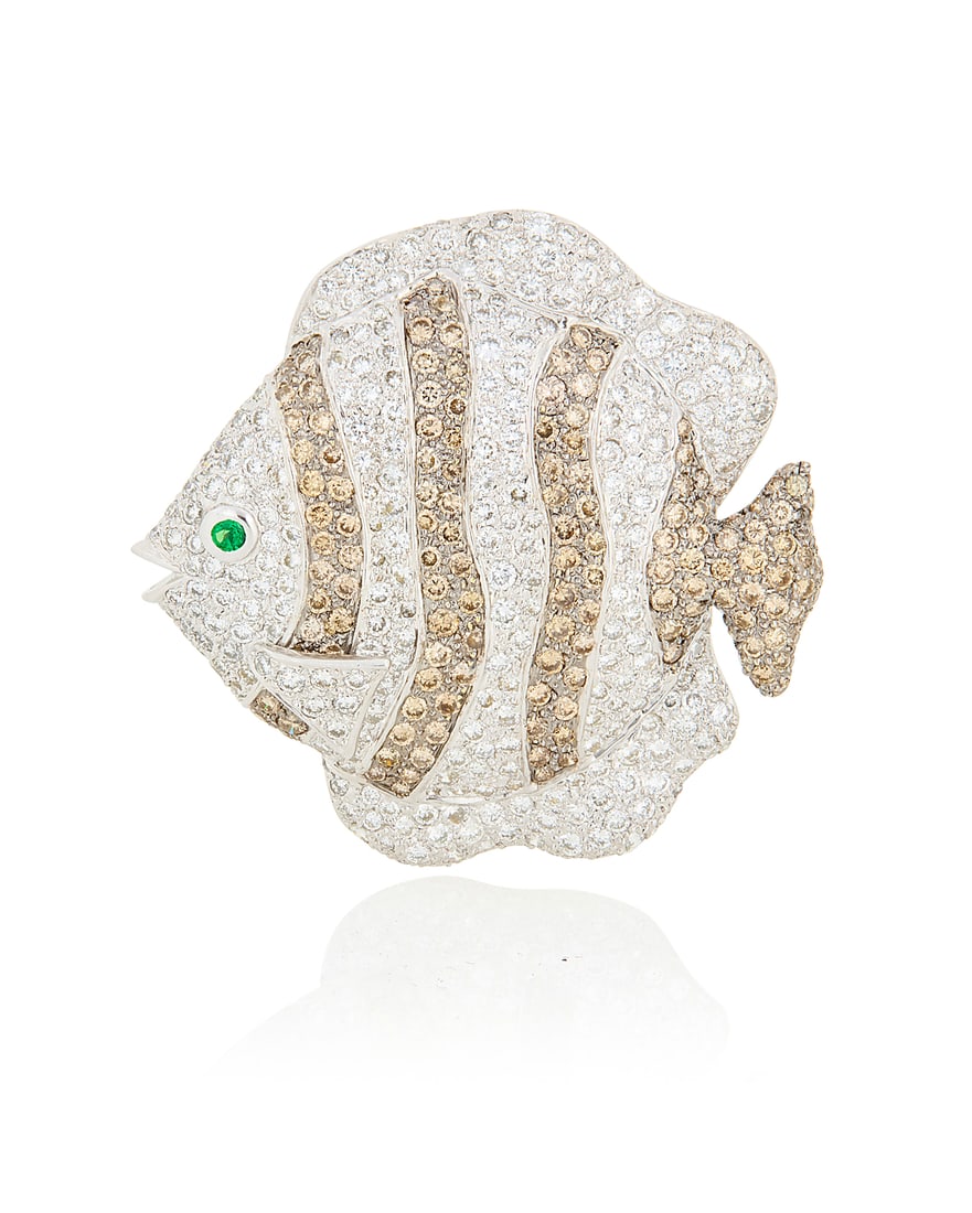 An 18K White Gold, Diamond and Emerald Brooch Of a tropical fish design featuring bands of round: An 18K White Gold, Diamond and Emerald Brooch Of a tropical fish design featuring bands of round brown and near-colorless diamonds weighing approximately 6.50 carats, finished with a round emerald eye