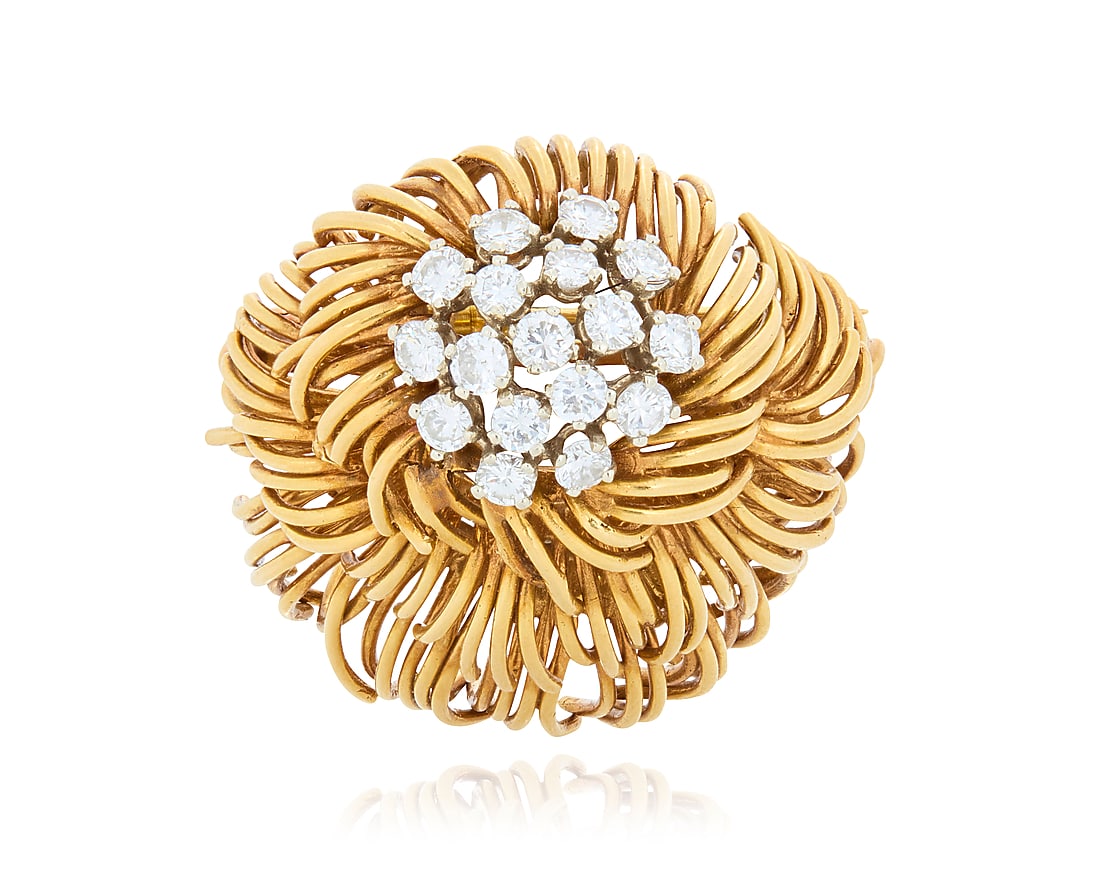 An 18K Gold and Diamond Brooch Of a tiered flowing organic design centering seventeen round: An 18K Gold and Diamond Brooch Of a tiered flowing organic design centering seventeen round diamonds weighing approximately 2.35 carats Measures: 1 1/2 x 1 1/2 in. 28.5 grams gross