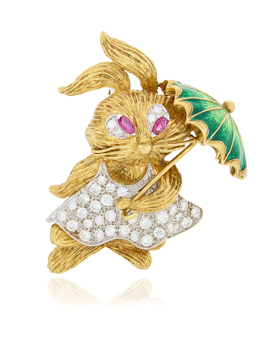 An 18K Bi-Color Gold, Enamel and Diamond Brooch Featuring a dressed rabbit dancing with a green: An 18K Bi-Color Gold, Enamel and Diamond Brooch Featuring a dressed rabbit dancing with a green enamel umbrella, accented by round diamonds weighing approximately 3.00 carats, finished with two marqui