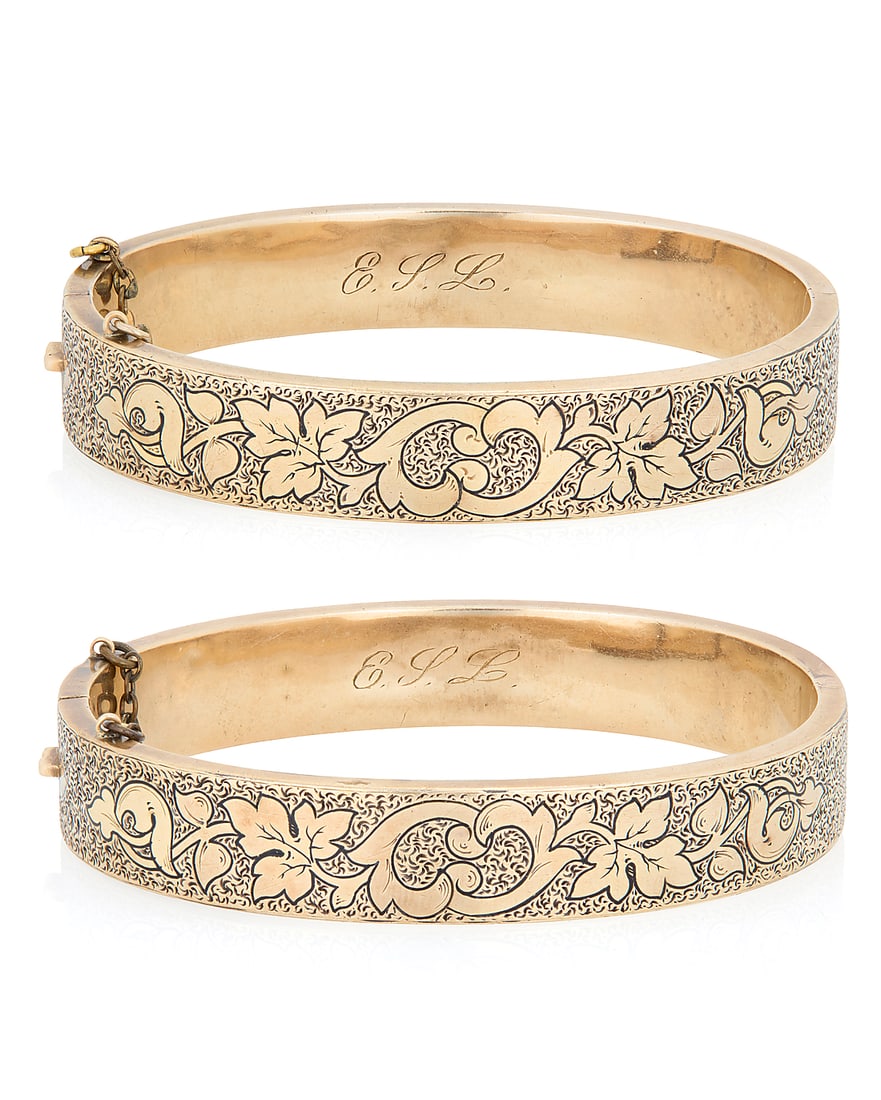 A Pair of Victorian 14K Gold and Black Enamel Bangles Of a hinged design featuring floral motifs, (1 of 2)