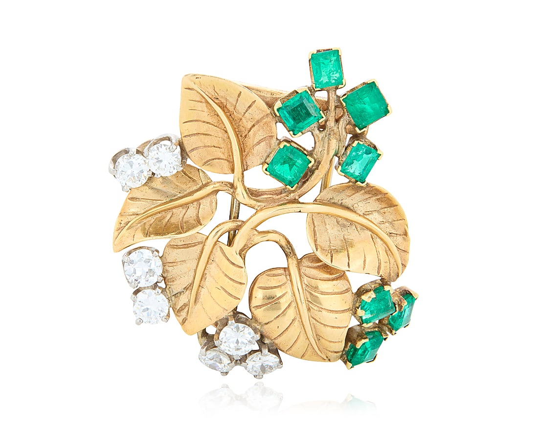Seaman Schepps: A 14K Bi-Color Gold, Emerald and Diamond Flower Brooch Of a foliate design (1 of 3)
