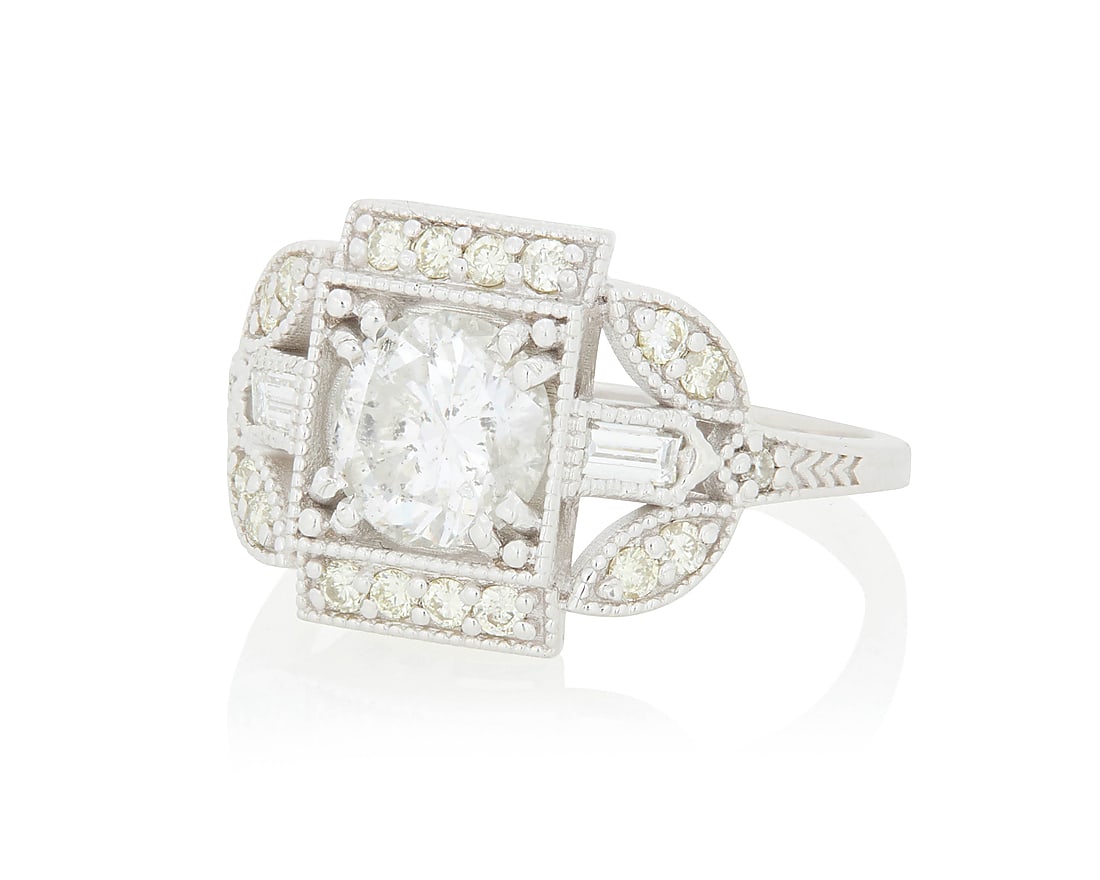 A 14K White Gold and Diamond Ring Of a Geometric floral design centering a round diamond weighing: A 14K White Gold and Diamond Ring Of a Geometric floral design centering a round diamond weighing approximately 1.34 carats, accented by round and baguette diamonds Size: 7 4.4 grams gross