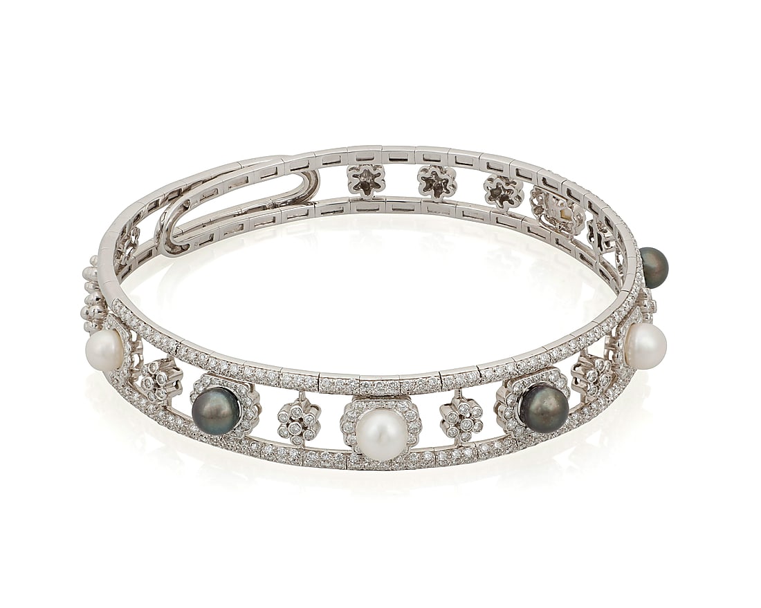 An 18K White Gold, Cultured Pearl and Diamond Collar Necklace Of a banded design featuring seven: An 18K White Gold, Cultured Pearl and Diamond Collar Necklace Of a banded design featuring seven grey and white cultured pearls measuring approximately 8.40 mm, accented by round diamonds weighing app