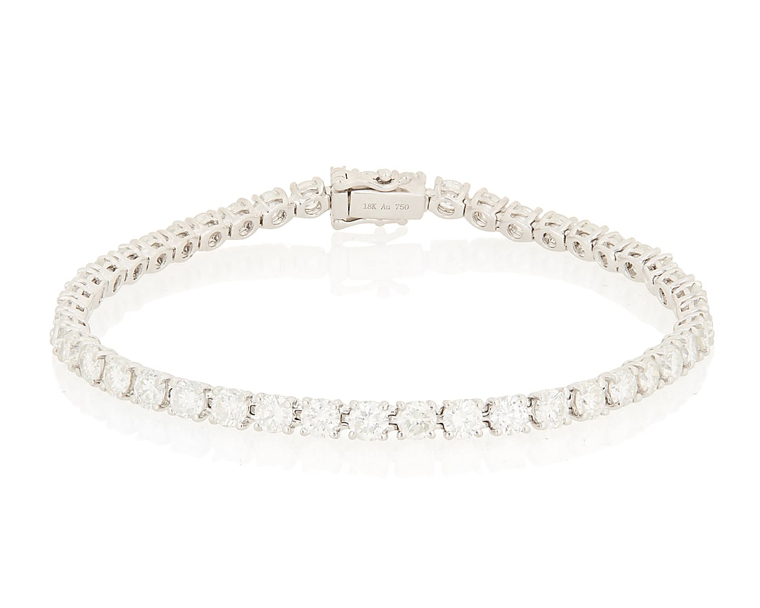 An 18K White Gold and Diamond Bracelet Of a single line design featuring forty-two round diamonds (1 of 3)