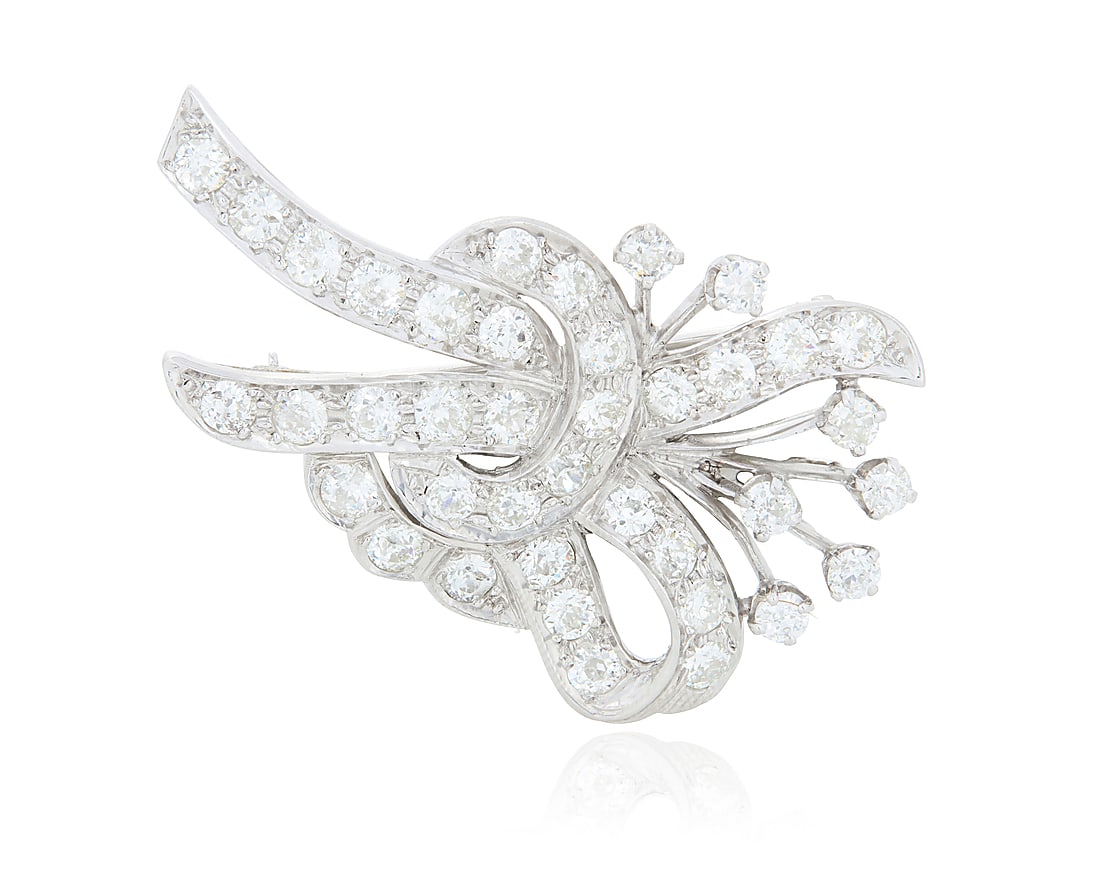 A Platinum and Diamond Brooch Of a ribbon design featuring old European-cut diamonds weighing (1 of 3)