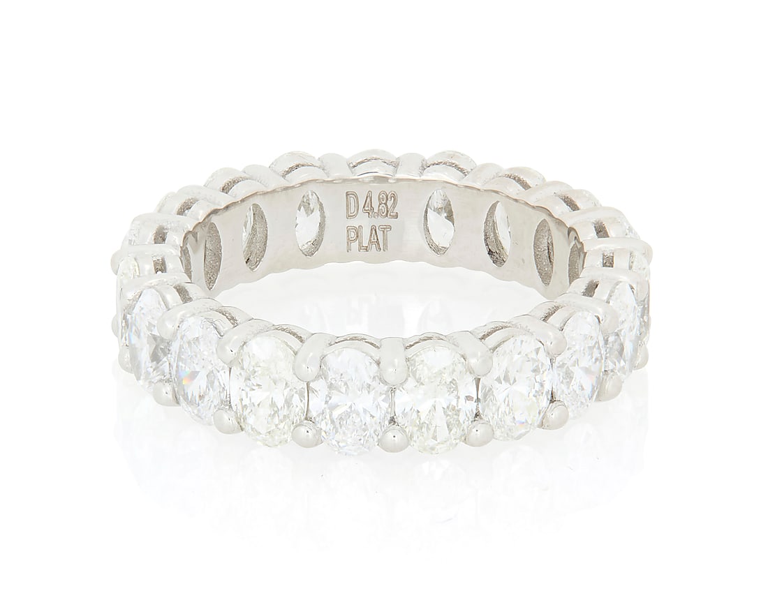 A Platinum and Diamond Eternity Ring Featuring nineteen oval diamonds weighing approximately 4.80: A Platinum and Diamond Eternity Ring Featuring nineteen oval diamonds weighing approximately 4.80 carats Size: 6 1/2 7.3 grams gross