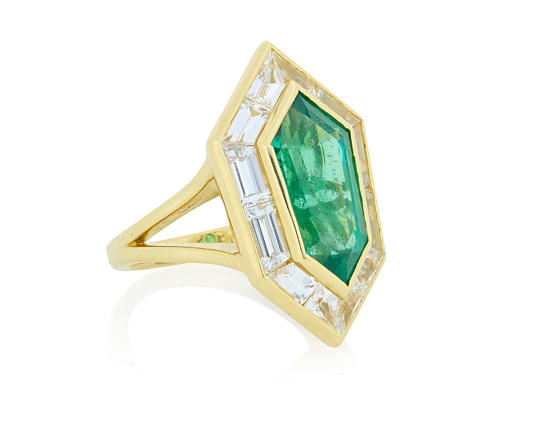 An 18K Gold, Emerald and Diamond Ring Centering an elongated shield shaped emerald weighing (1 of 3)