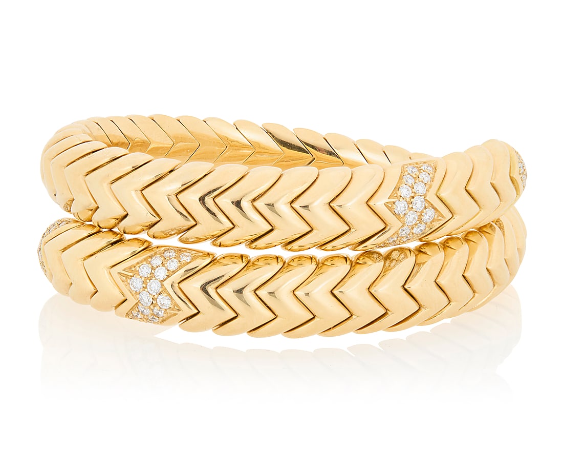 Bulgari: An 18K Gold and Diamond 'Spiga' Bracelet Of a flexible design featuring chevron motif: Bulgari: An 18K Gold and Diamond 'Spiga' Bracelet Of a flexible design featuring chevron motif links accented by round diamonds weighing approximately 0.90 carat, signed Bulgari with Italian workshop 