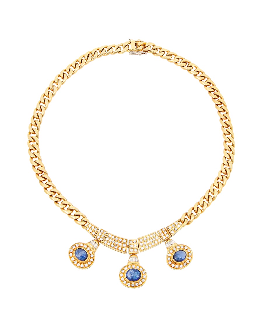 An 18K Gold, Sapphire, and Diamond Necklace Featuring a Cuban link chain centering diamond set: An 18K Gold, Sapphire, and Diamond Necklace Featuring a Cuban link chain centering diamond set links suspending three oval sapphire double cabochons, estimated total diamond weight 2.75 carats Length: