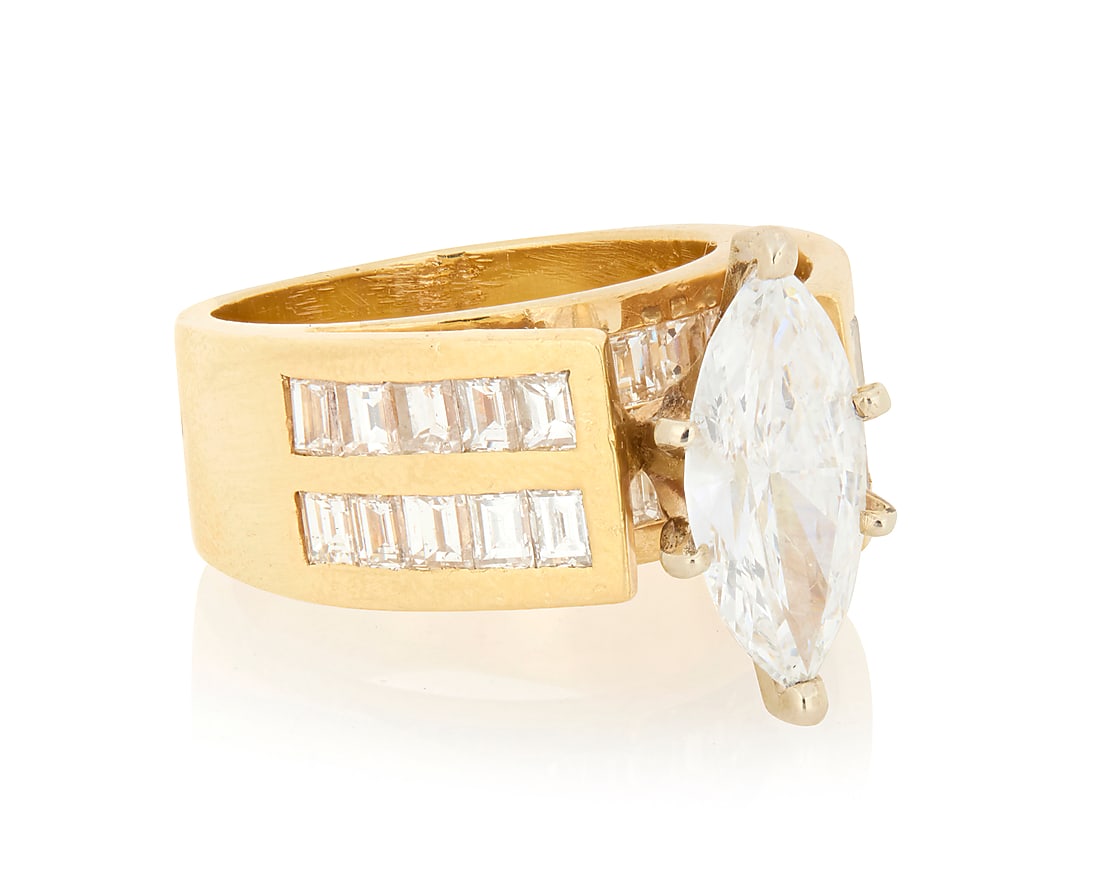 A 14K Gold and Diamond Ring Centering a high set marquise-shaped diamond weighing approximately (1 of 4)