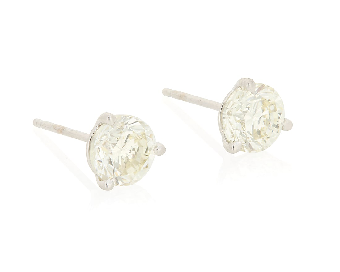 A Pair of 14K Gold and Diamond Stud Earrings Centering two round diamonds weighing approximately (1 of 3)