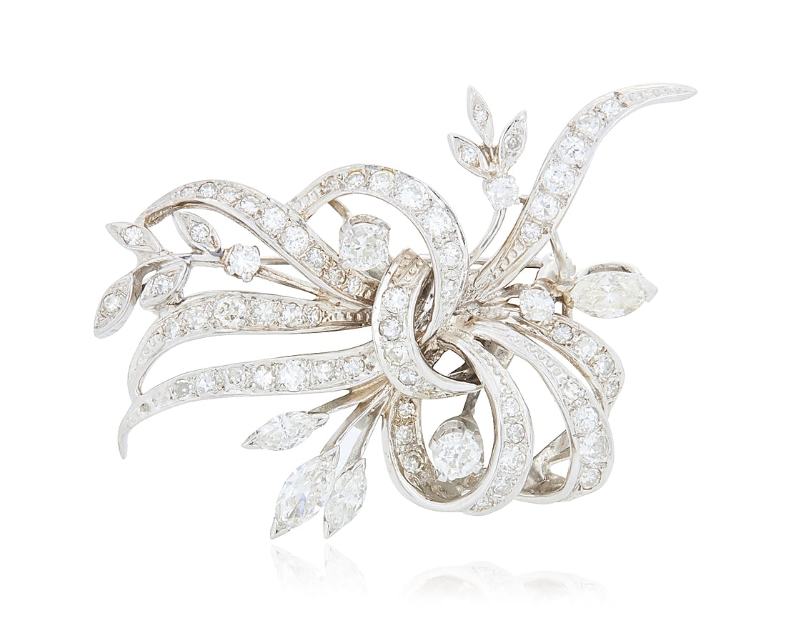 A 14K White Gold and Diamond Brooch Of a swirling ribbon design set with marquise-shaped, round, (1 of 3)