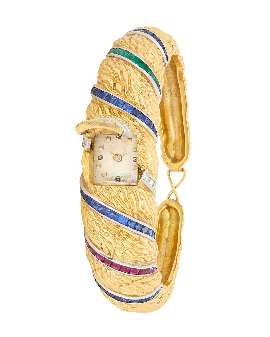A Bi-Color Gold, Ruby, Sapphire, and Diamond Surprise Watch Of a textured domed design featuring (1 of 5)