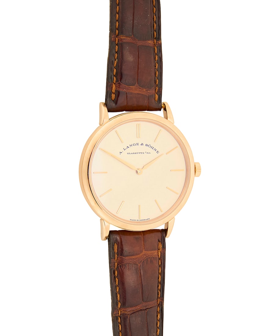 A. Lange & Sohne: An 18K Rose Gold 'Saxiona Thin' Watch Dial: 30.00 mm, round with baton marks: A. Lange & Sohne: An 18K Rose Gold 'Saxiona Thin' Watch Dial: 30.00 mm, round with baton marks Case: 38.00 mm Case number: 238338, movement 128205 Closure: brown leather strap with 18k rose gold buckl