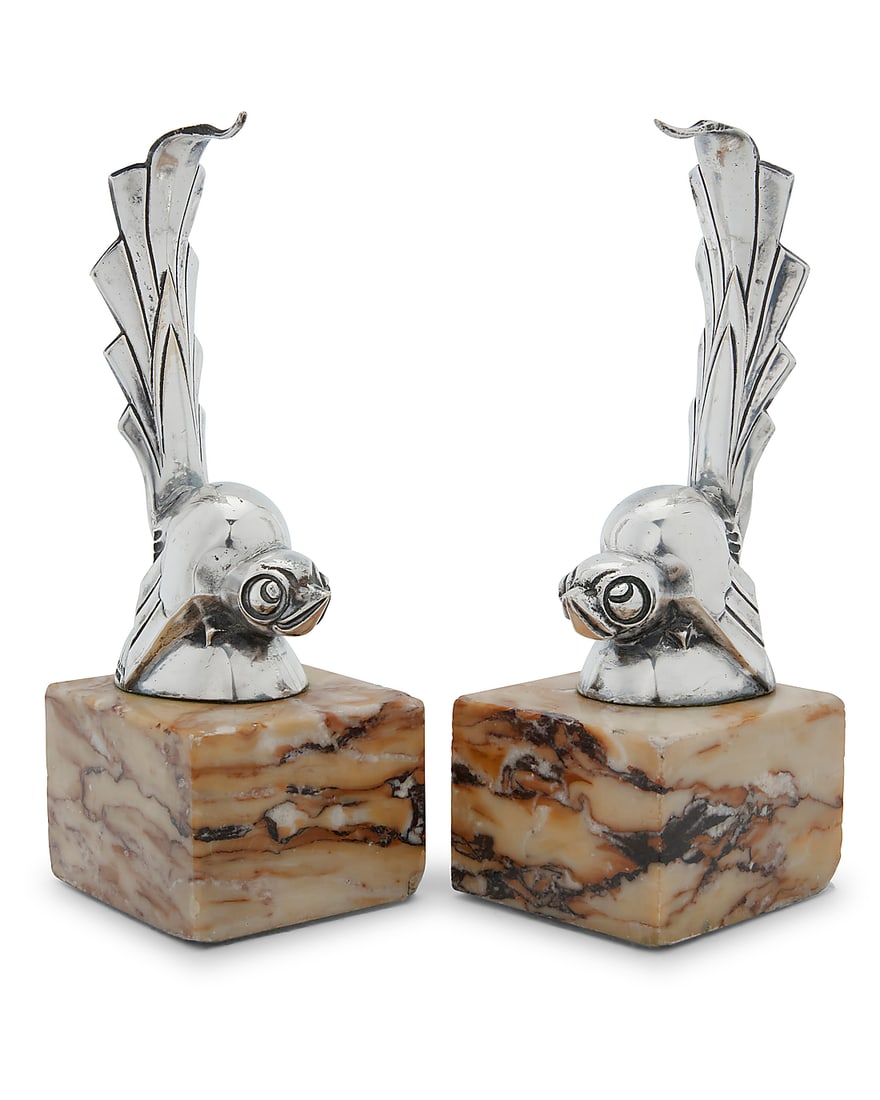 Gaston Rischmann (1907-1979) A pair of Art Deco silver-plated watch stands, mid-20th century Each: Gaston Rischmann (1907-1979) A pair of Art Deco silver-plated watch stands, mid-20th century Each in the form of a bird, on marble base One marked: Rischmann / FRANCE; the other: G Rischmann / FRANCE 