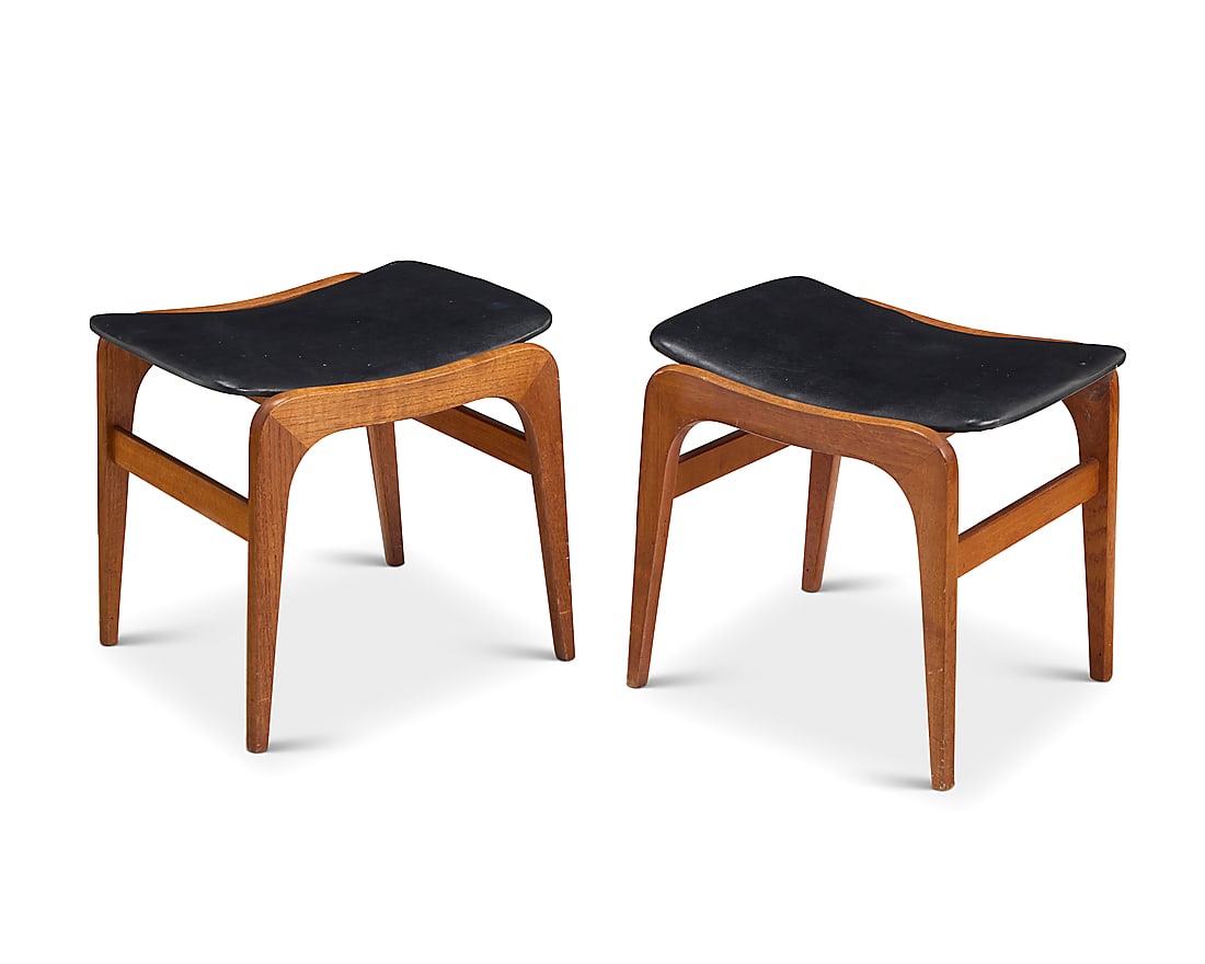 A pair of Modern teak and leather stools Mid-20th century Each with leather-wrapped seat, raised: A pair of Modern teak and leather stools Mid-20th century Each with leather-wrapped seat, raised on U-form supports joined by bar stretchers With applied paper factory labels to underside: S. BROWN CO