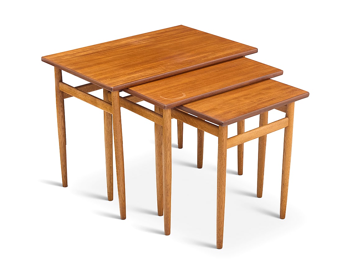 A nest of three Modern teak tables: A nest of three Modern teak tables Mid-20th century In graduated sizes Each unmarked 3 pieces Height of largest 18 3/4 in., width 24 in., depth 16 in.; height of shortest 17 1/4 in.