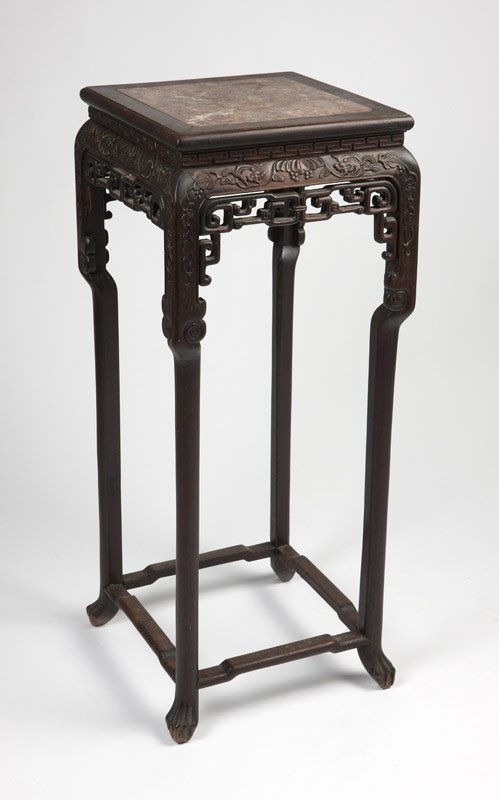 A Chinese carved wood table / stand: Late 19th century, the square top with inset pink marble panel, the apron relief-carved with flowers and mice, 42'' H x 17'' W x 17'' D, est: $500/800