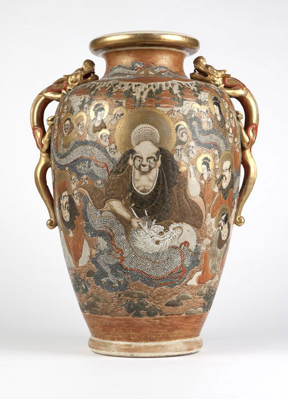 A large Satsuma earthenware vase: Meiji era, signed with red and gilt mon and four-character cartouche, the baluster-form body polychrome and gilt-decorated with two dragons and a profusion of figures and faces with pavilions in the d