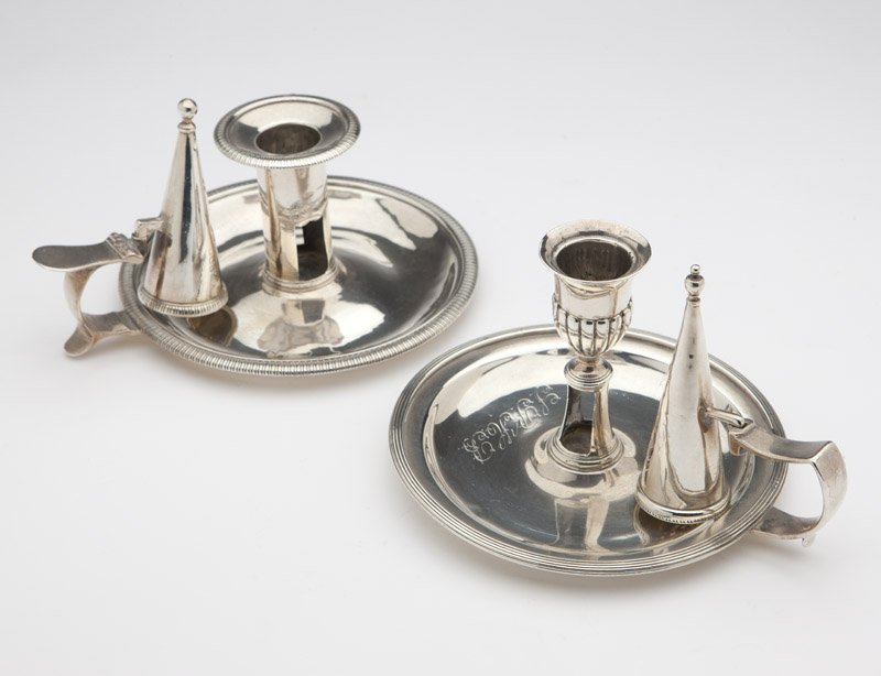 Two George III sterling silver chamber-candlesticks: The first: 1799, London, maker's mark of Richard Cooke, further marked ''1799'', with an urn-form socket gadrooned to the lower half, the circular base with reeded rim, monogrammed to base and snuffer