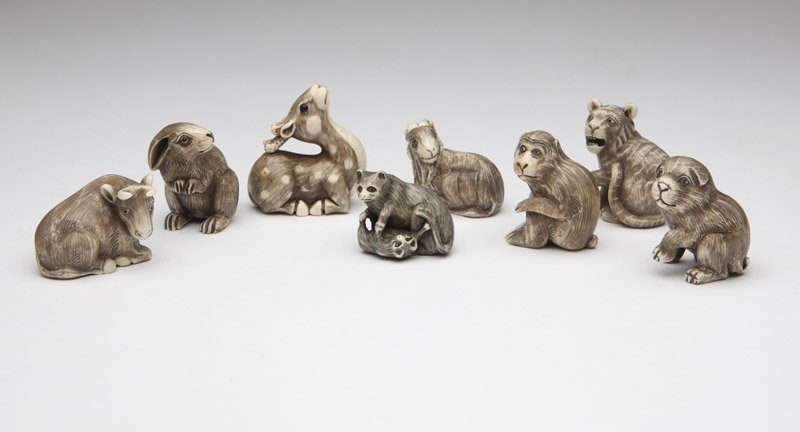 Eight ivory netsuke of fauna: Each signed, the first: a dog (1.75'' H x 1.25'' W); the second: a seated monkey (1.5'' H x 1.125'' W); the third: a tiger (1.5'' H x 1.25'' W); the fourth: a faun (1.75'' H x 1.75'' W); the fifth: a 