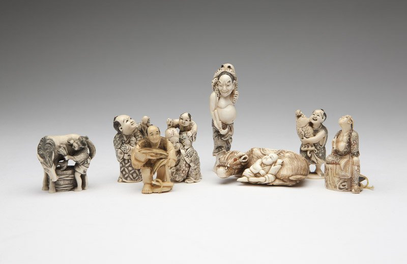 Eight ivory netsuke: Each signed, the first: a man holding a bundle (1.75'' H x 1.125'' W); the second: two figures, one wearing a carapace (2'' H x 1'' W); the third: a man holding a chicken and an egg (1.875'' H x 1'' W