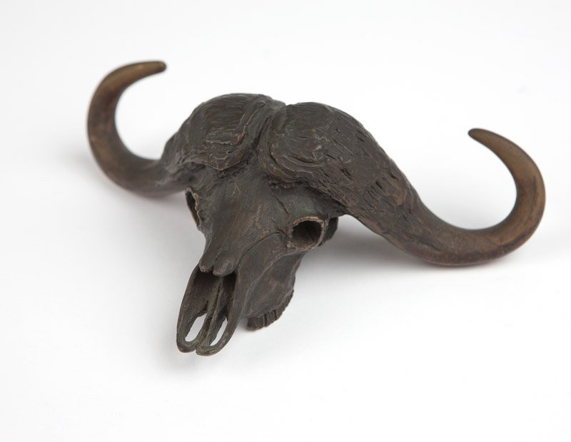 Robert Glen (1940-* Kenya / American): Water buffalo skull, incised with signature and dated on the underside: Robert Glen 1981; numbered on the underside: 33/200, bronze with golden patina, 2.5'' H x 8'' W, est: $500/700