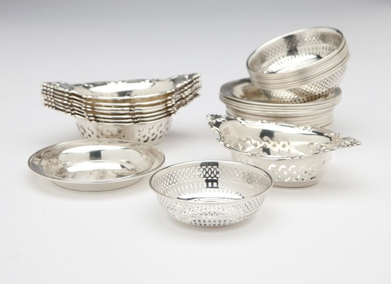 A group of American sterling silver hollowware: 20th century, various patterns and makers, each marked ''Sterling'', comprising: 8 Gorham 'Cromwell' nut dishes (1'' H x 3.75'' W x 2.5'' D); 9 International Silver Co. pierced salt cellars (lacking g